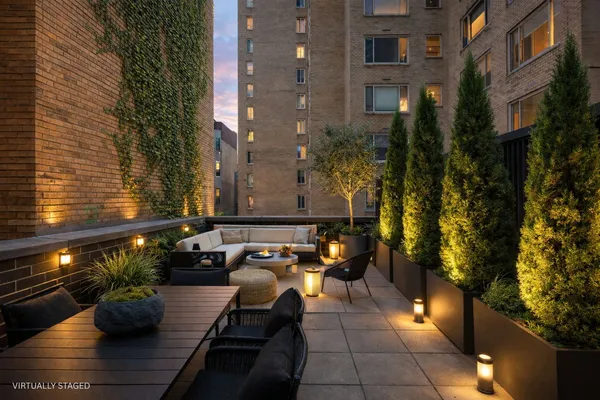 a view of a patio with couches and potted plants
