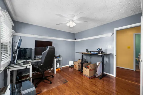 a view of a workspace with furniture and wooden floor