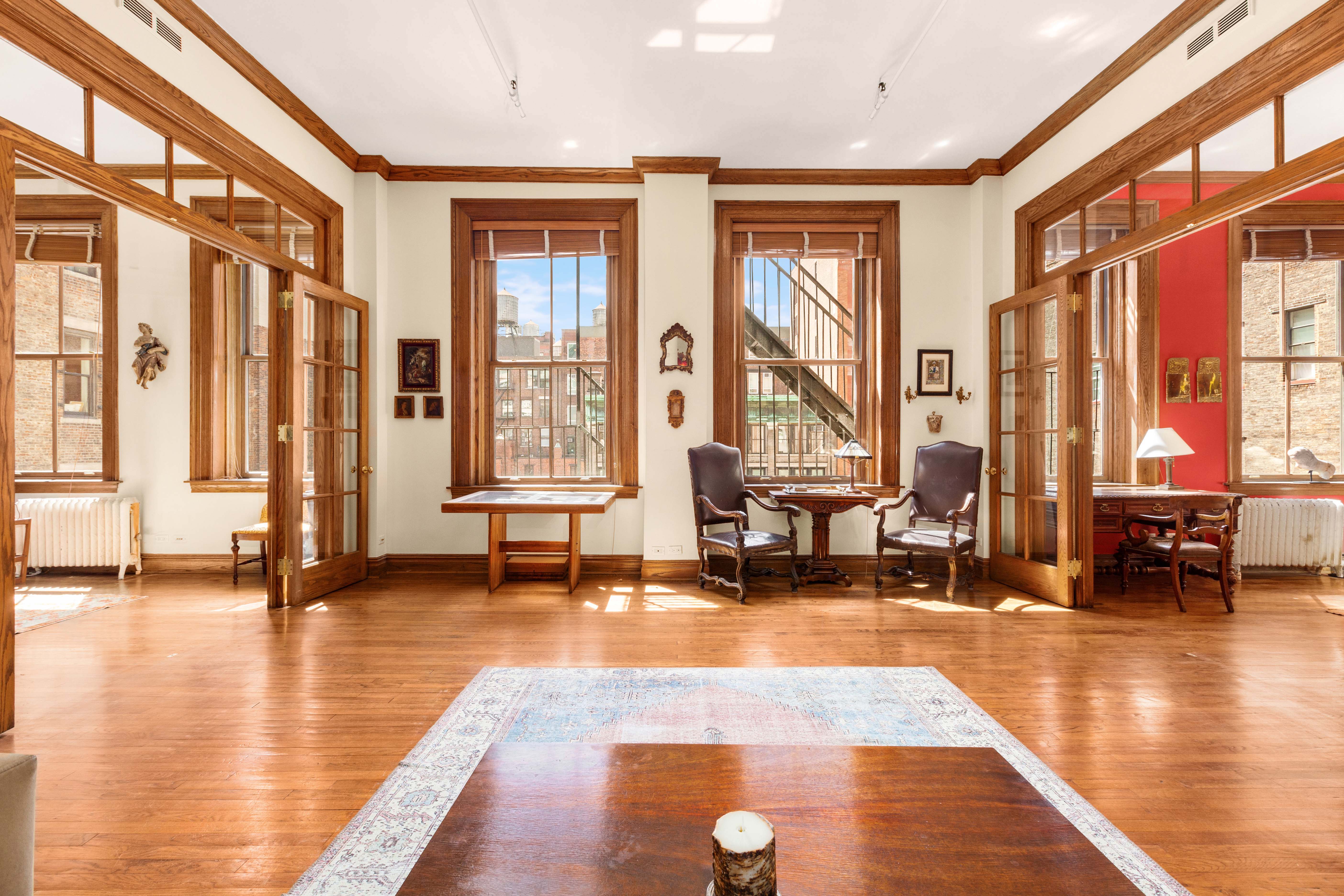 30 East 21st Street, Unit 6B Manhattan, NY 10010 - Photo 2 of 16 a living room with furniture and floor to ceiling windows