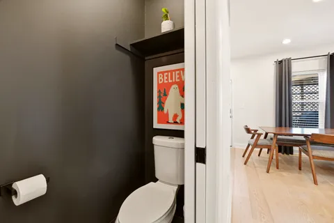 a bathroom with a toilet a sink and a window