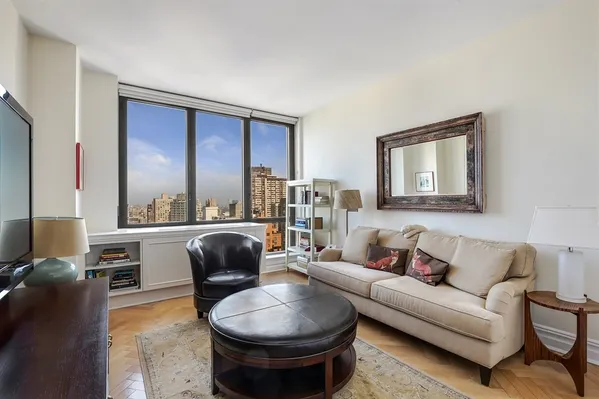 a living room with furniture and a large window