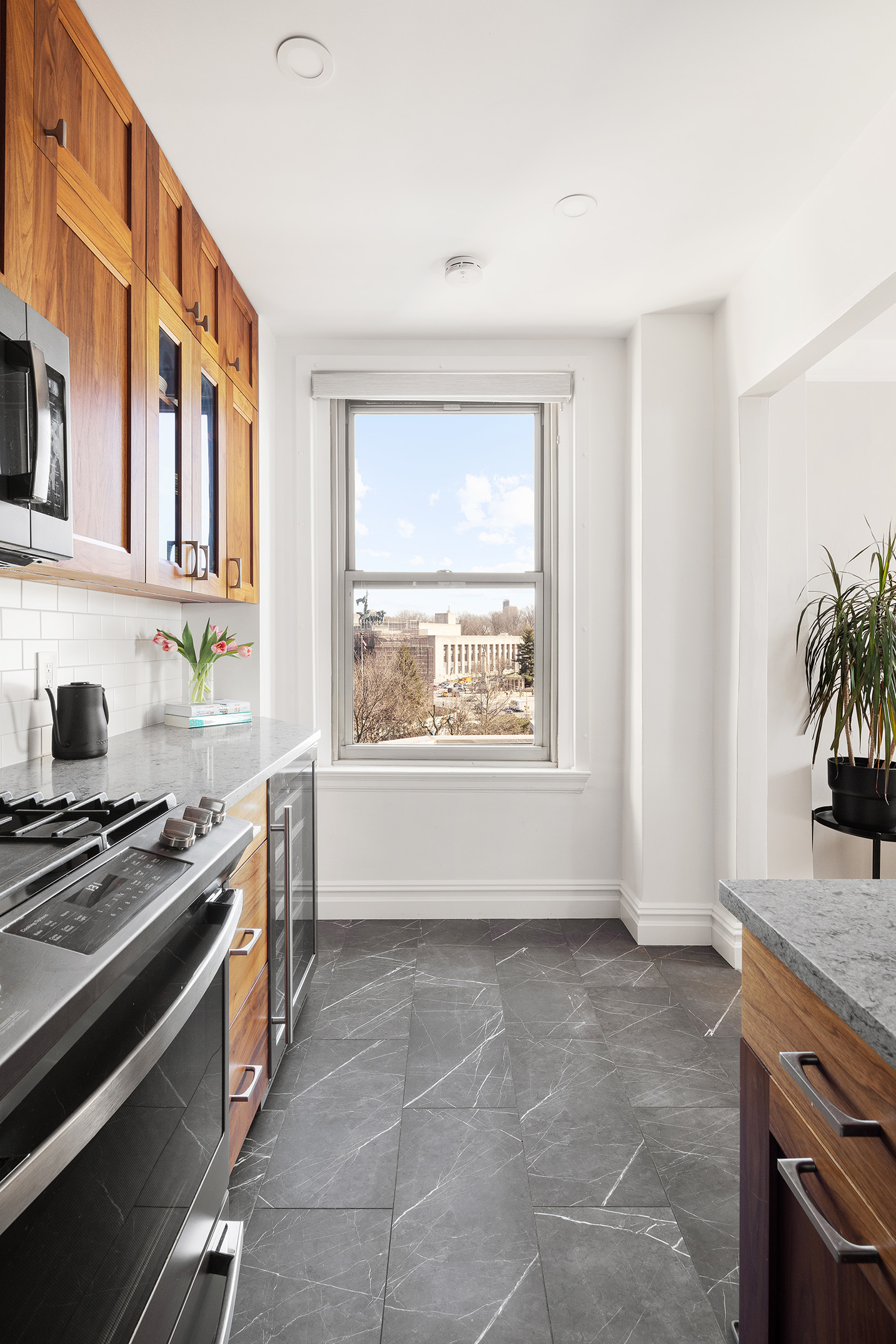 39 Plaza Street West, Unit 7C Brooklyn, NY 11217 - Photo 4 of 12 a kitchen with granite countertop a stove and a sink