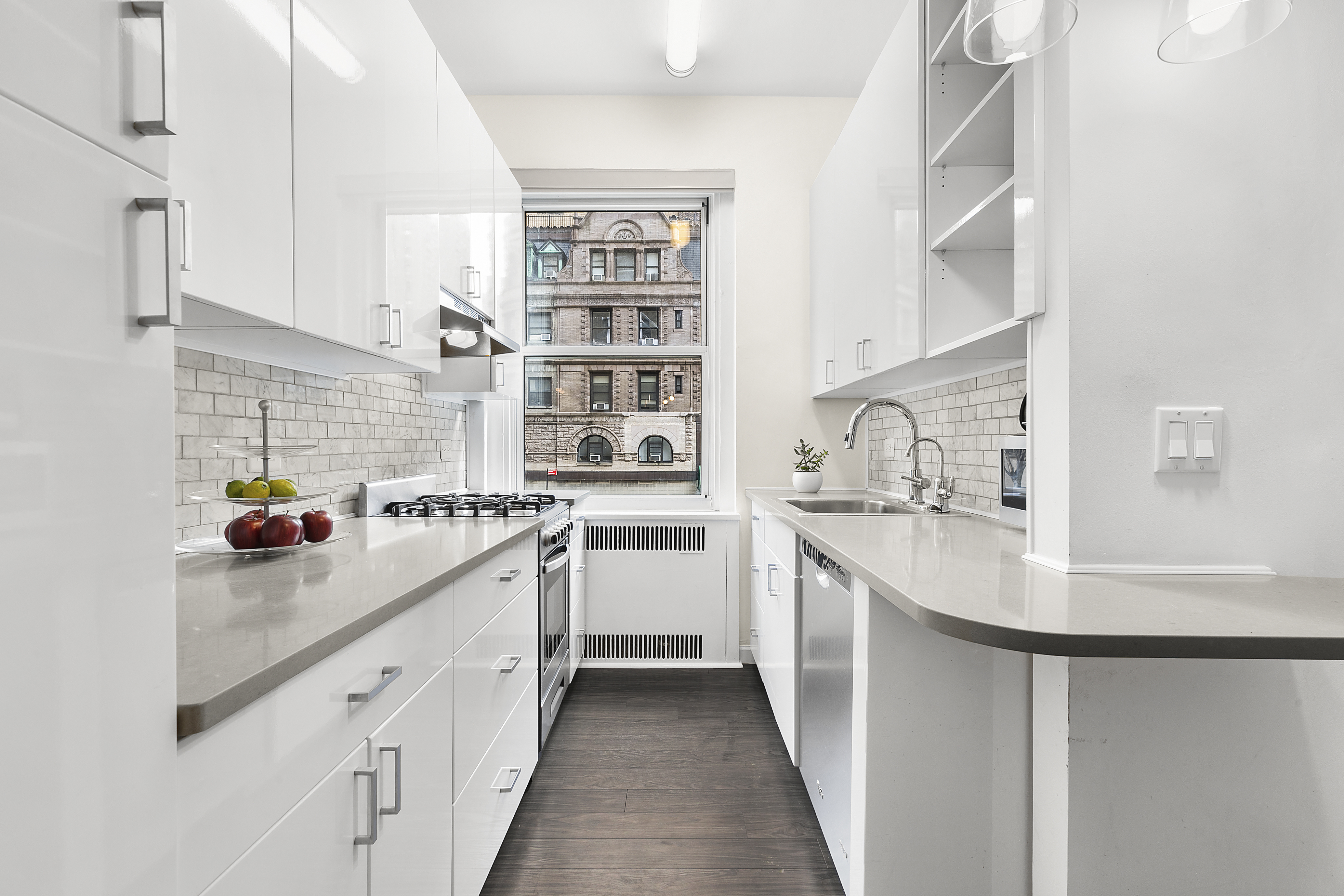 263 West End Avenue, Unit 2C Manhattan, NY 10023 - Photo 3 of 13 a kitchen with kitchen island a sink a stove and cabinets