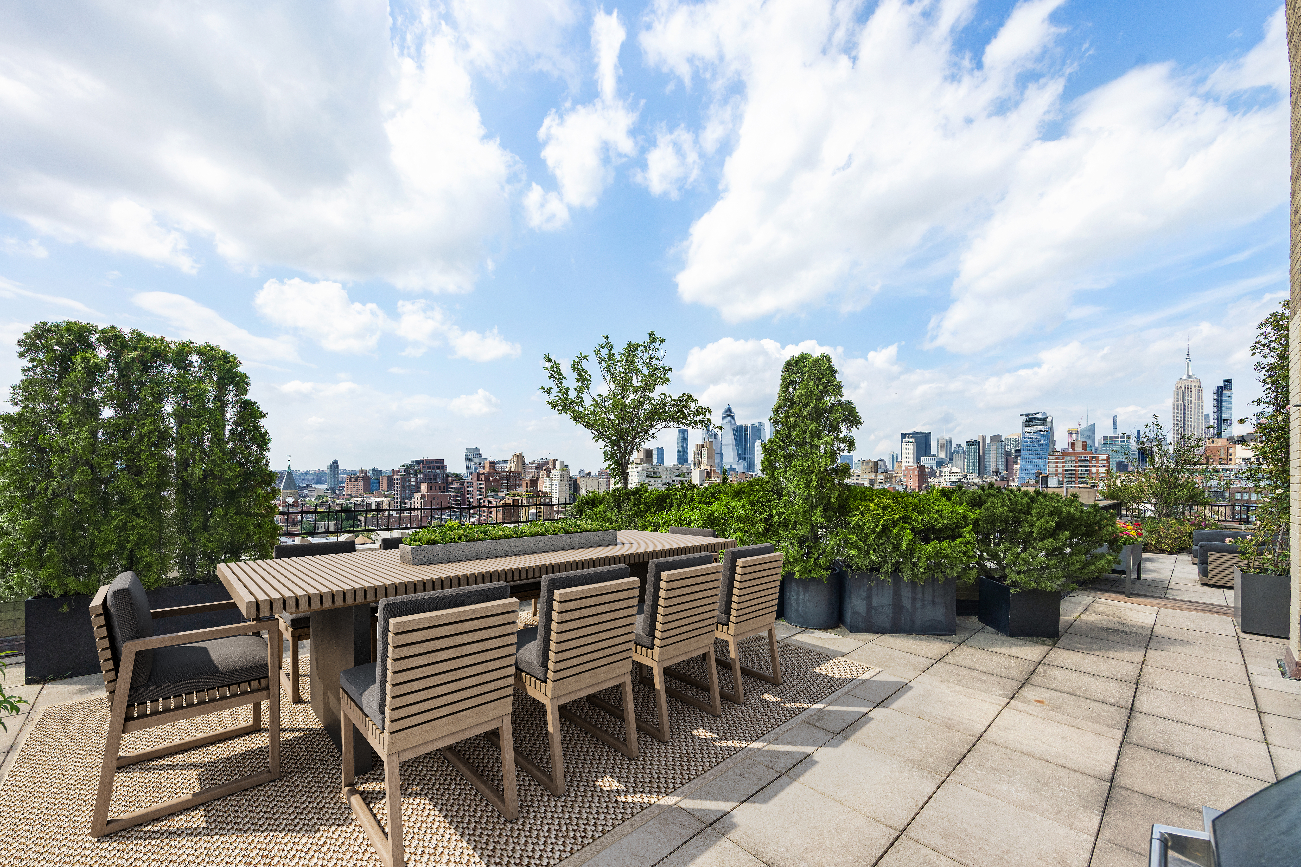 24 5th Avenue, Unit PH1701 Manhattan, NY 10011 - Photo 12 of 24 a patio with table and chairs