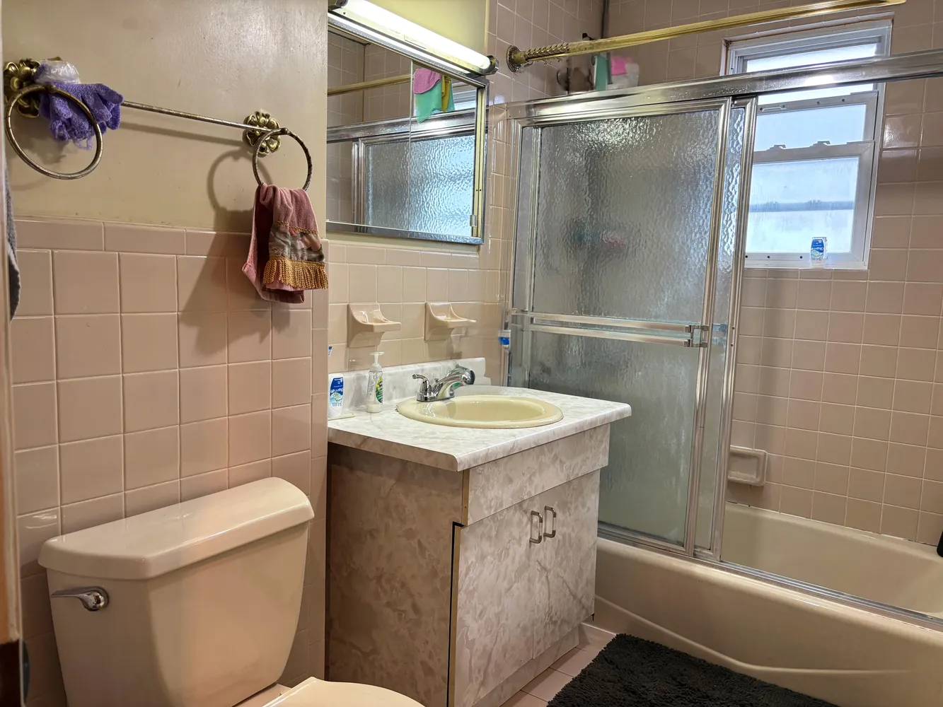 a bathroom with a sink toilet and shower