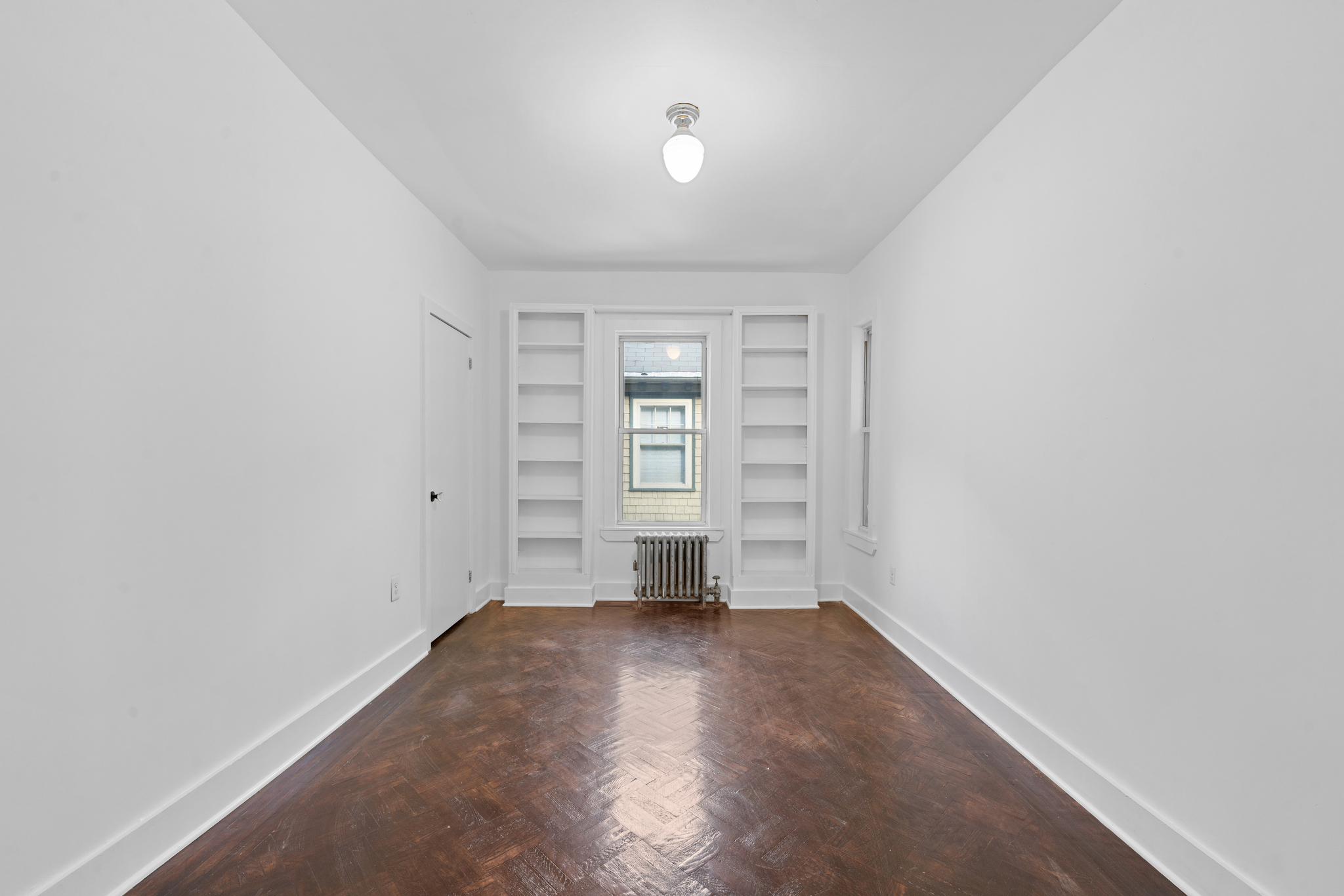 428 East 18th Street Brooklyn, NY 11226 - Photo 8 of 19 wooden floor in an empty room with a window