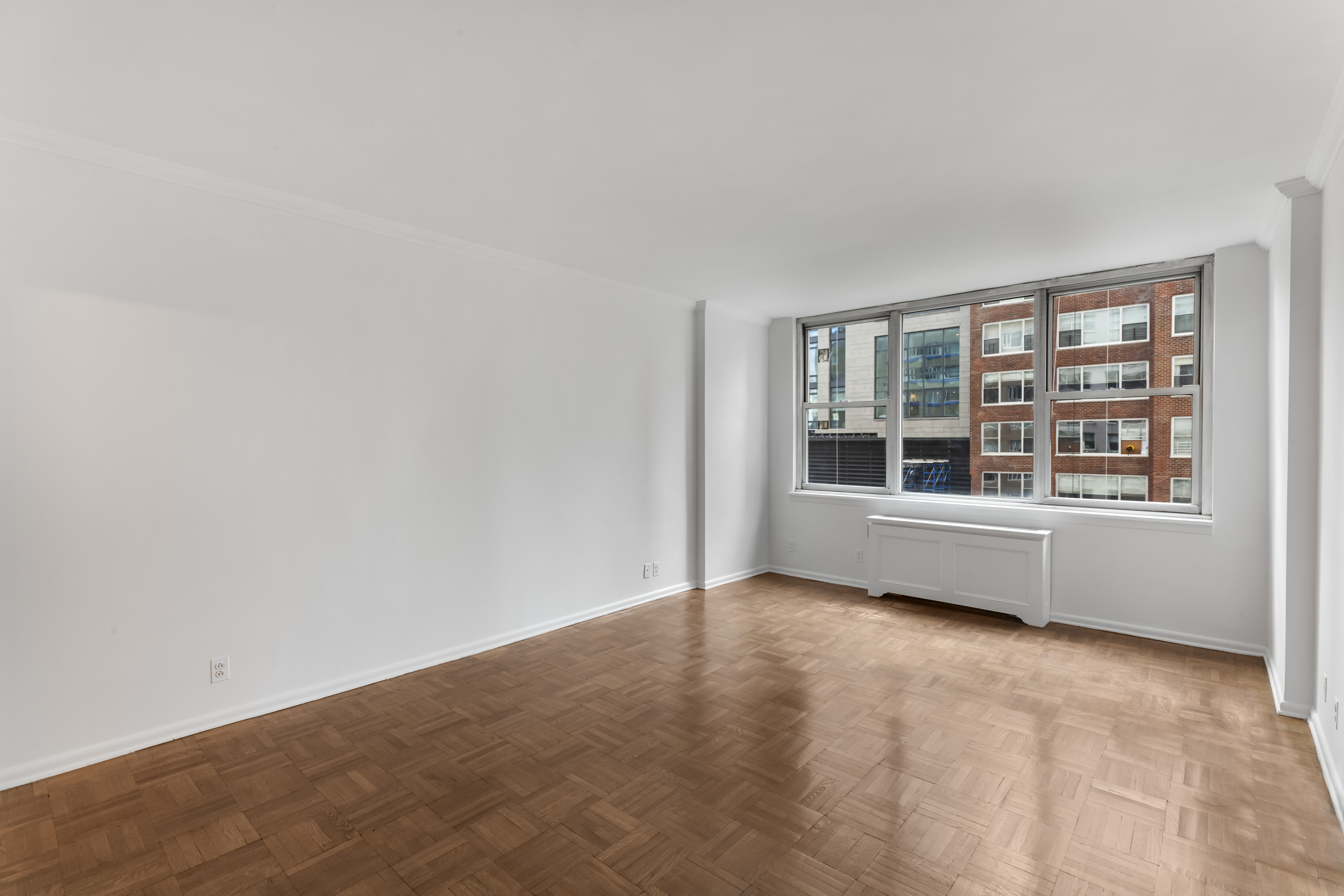 175 East 62nd Street, Unit 10B Manhattan, NY 10065 - Photo 9 of 12 a view of an empty room with a window