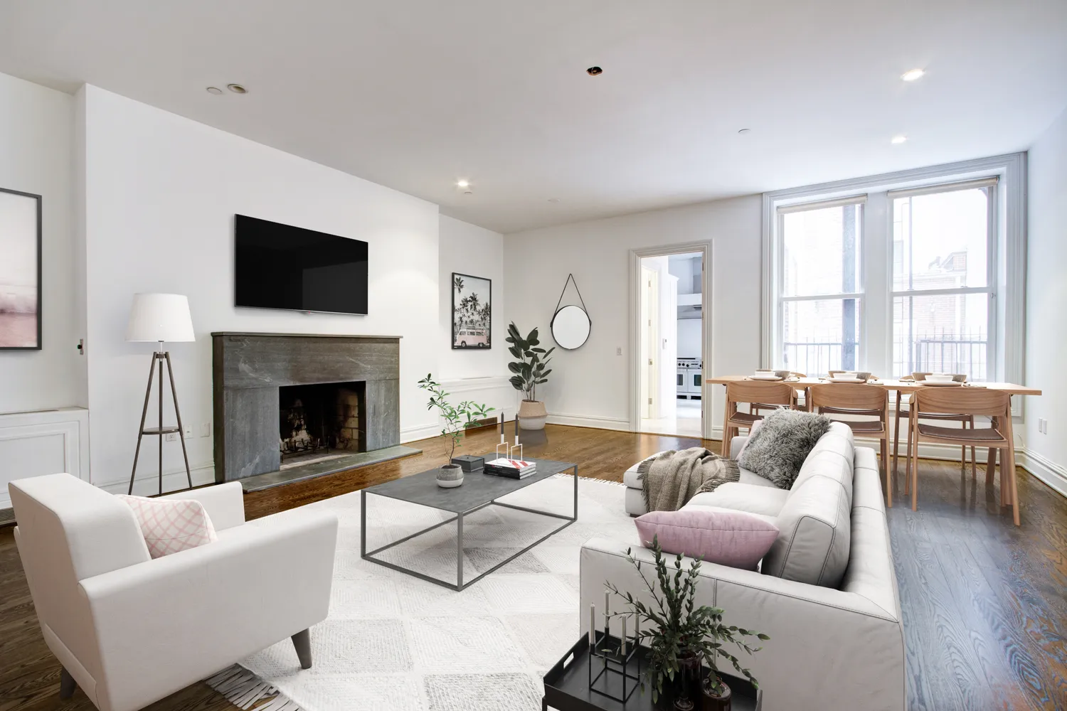 a living room with furniture a flat screen tv and a fireplace