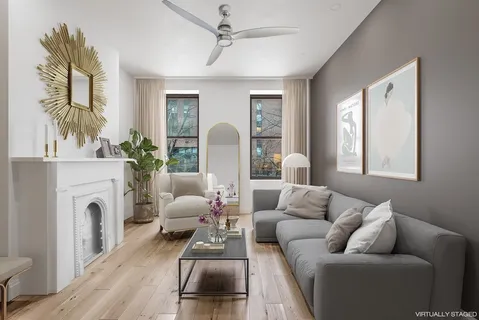 a living room with furniture and a fireplace