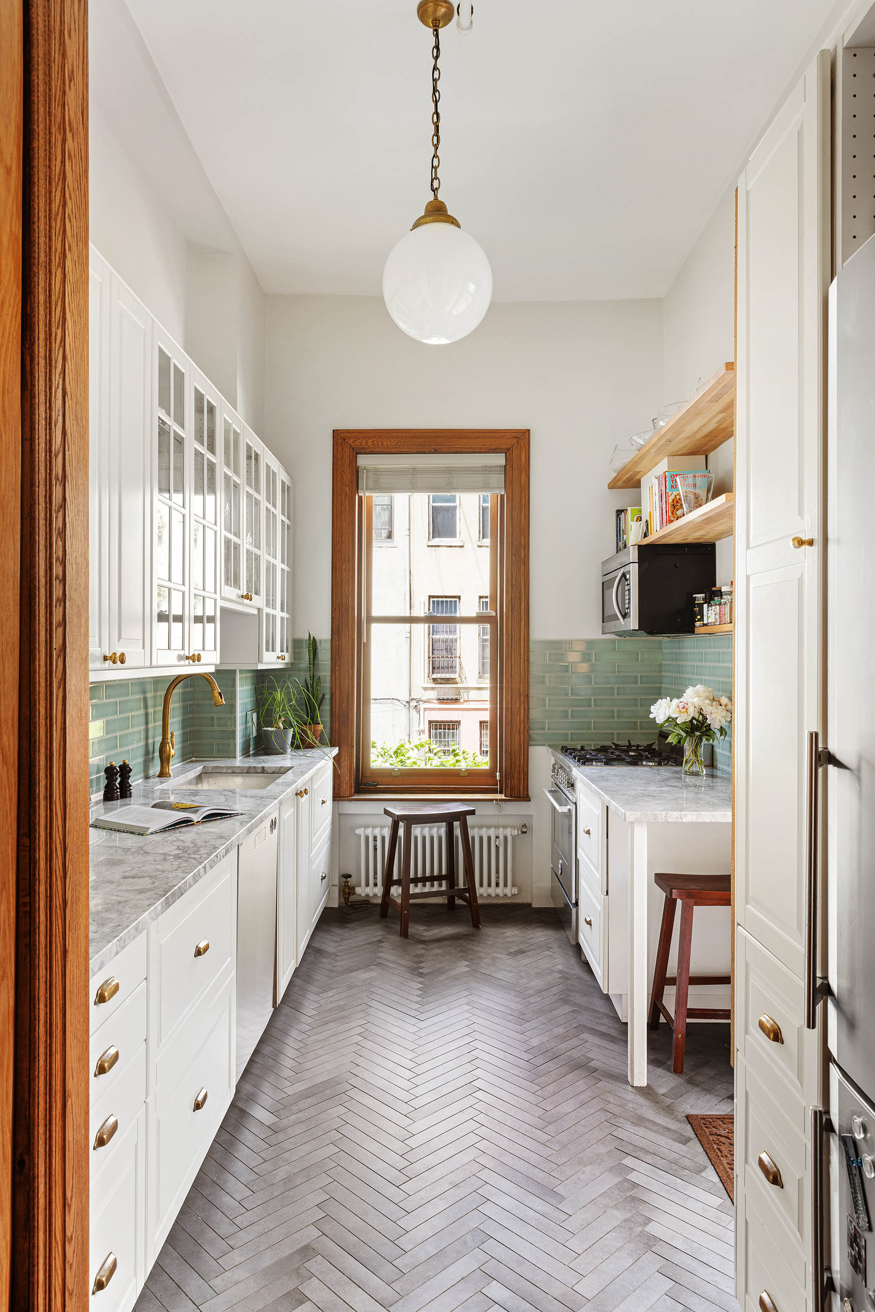 89 West 119th Street Manhattan, NY 10026 - Photo 7 of 22 a large white kitchen with granite countertop a stove a sink and a refrigerator