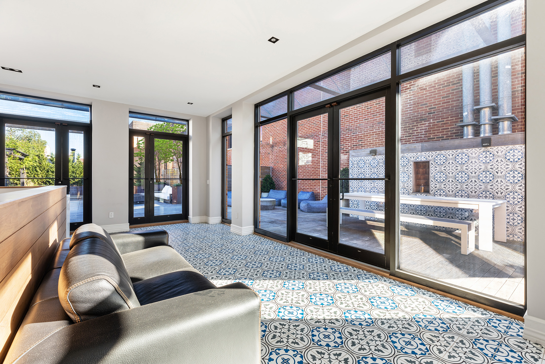 73 Wooster Street, Unit PHA Manhattan, NY 10012 - Photo 10 of 25 a living room with furniture and large windows