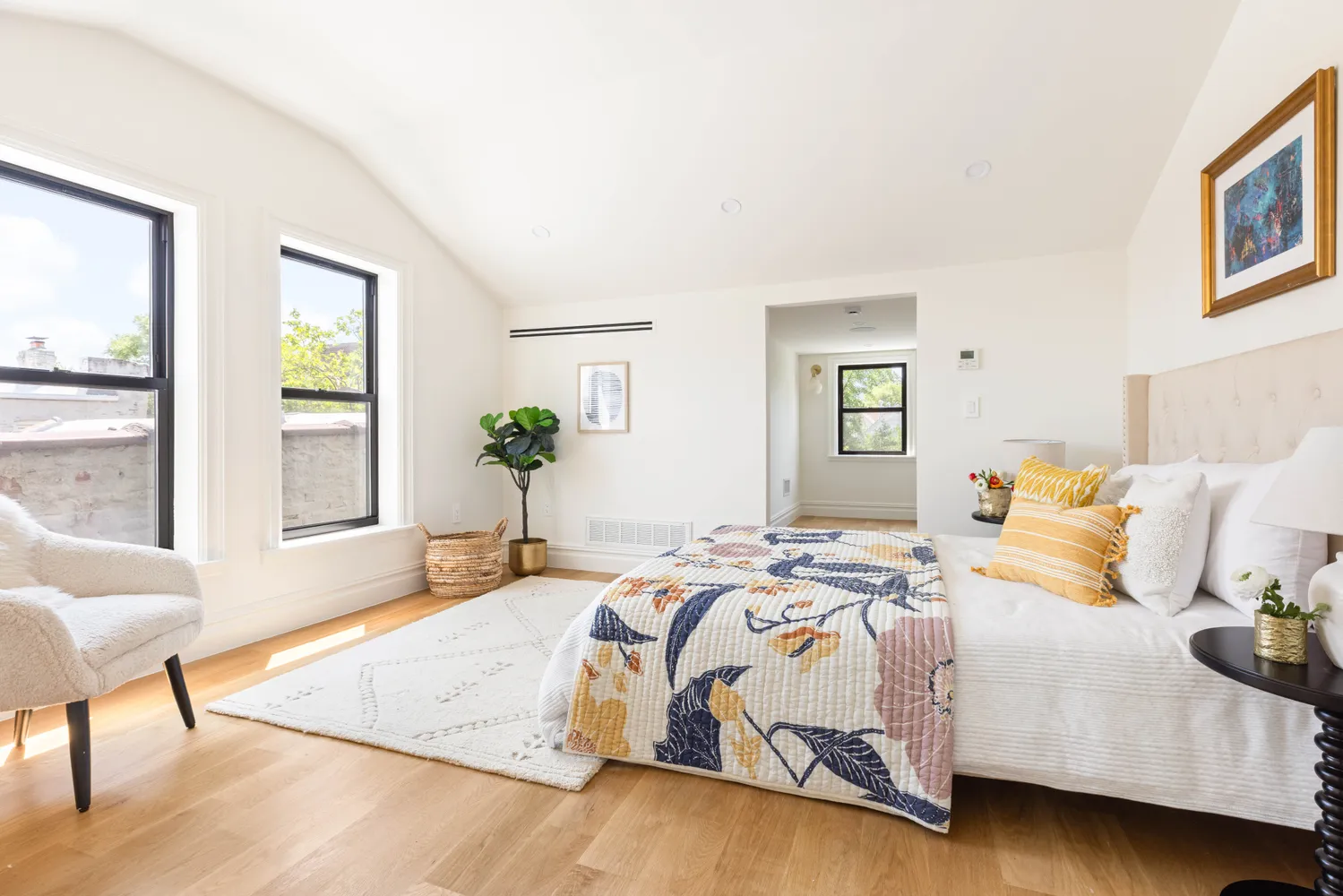 a bedroom with a bed and wooden floor