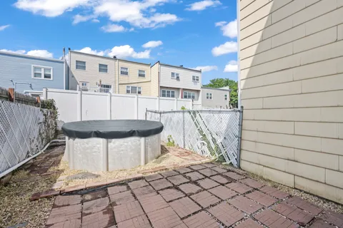 a backyard of a house with table and chairs
