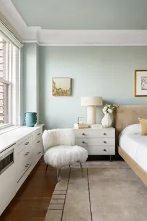 a bedroom with furniture and window