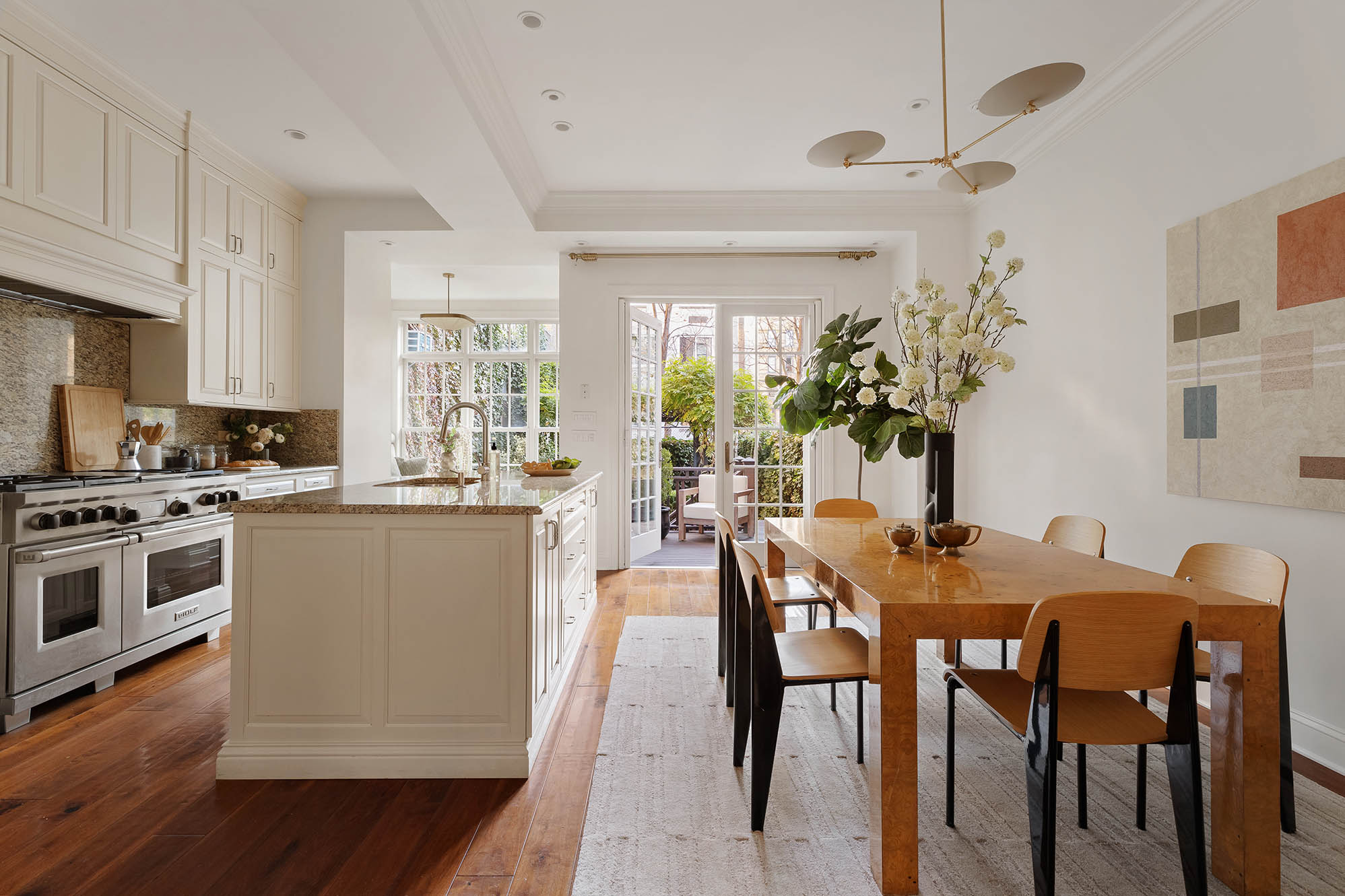 12 Leroy Street Manhattan, NY 10014 - Photo 3 of 20 a kitchen with stainless steel appliances granite countertop a stove a sink a microwave and a refrigerator