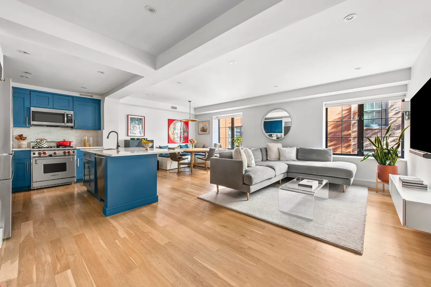 a living room with kitchen island furniture and a flat screen tv