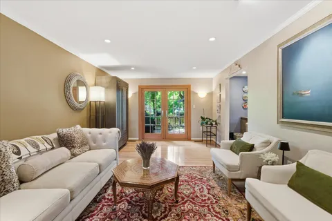 a living room with furniture and a wooden floor