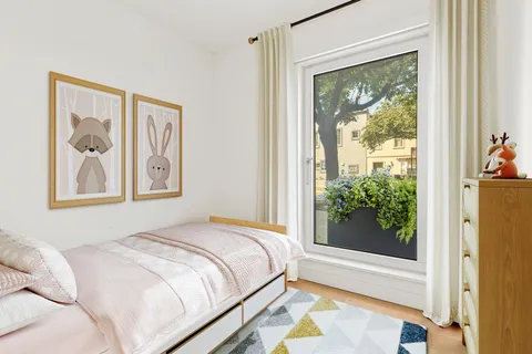 a bedroom with a bed and a painting on the wall