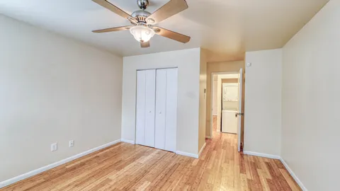 a view of empty room with wooden floor
