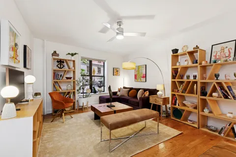 a living room with furniture cabinets and window