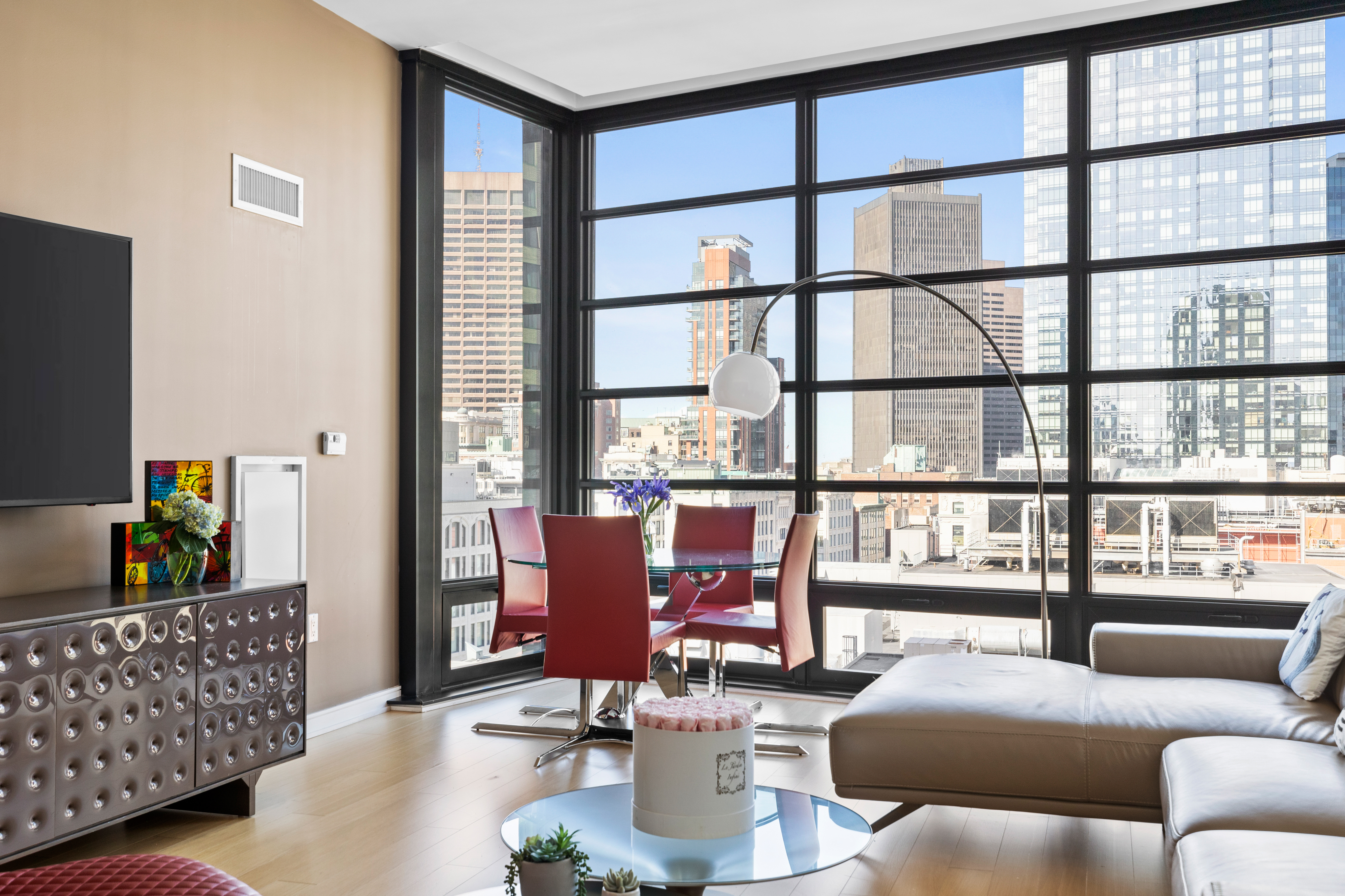 580 Washington Street, Unit PH5 Boston, MA 02111 - Photo 2 of 12 a living room with furniture and a window