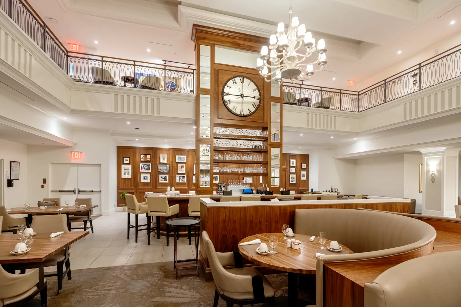a living room with dining table and a chandelier