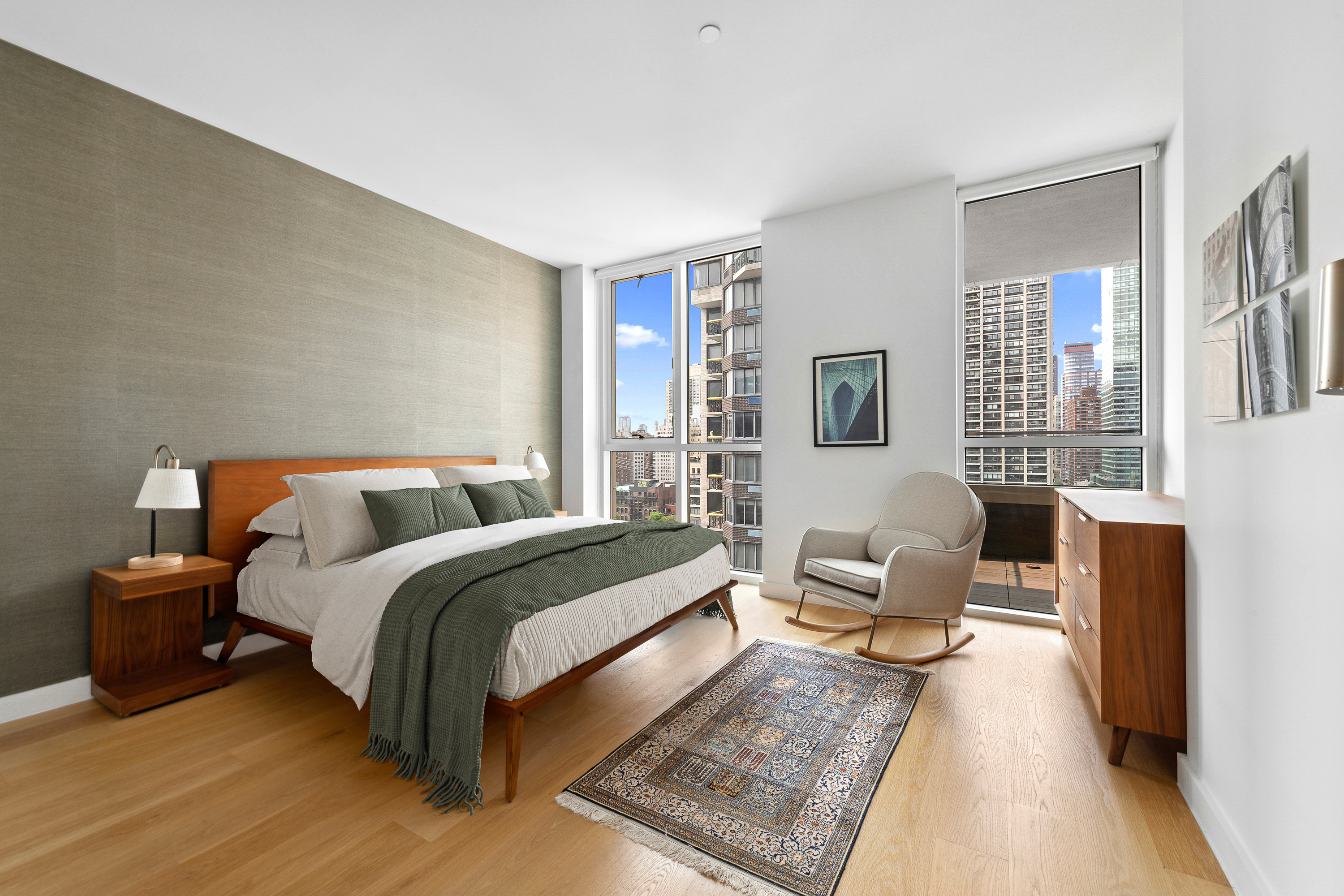 301 East 61st Street, Unit 12B Manhattan, NY 10065 - Photo 4 of 10 a bedroom with a bed and a couch