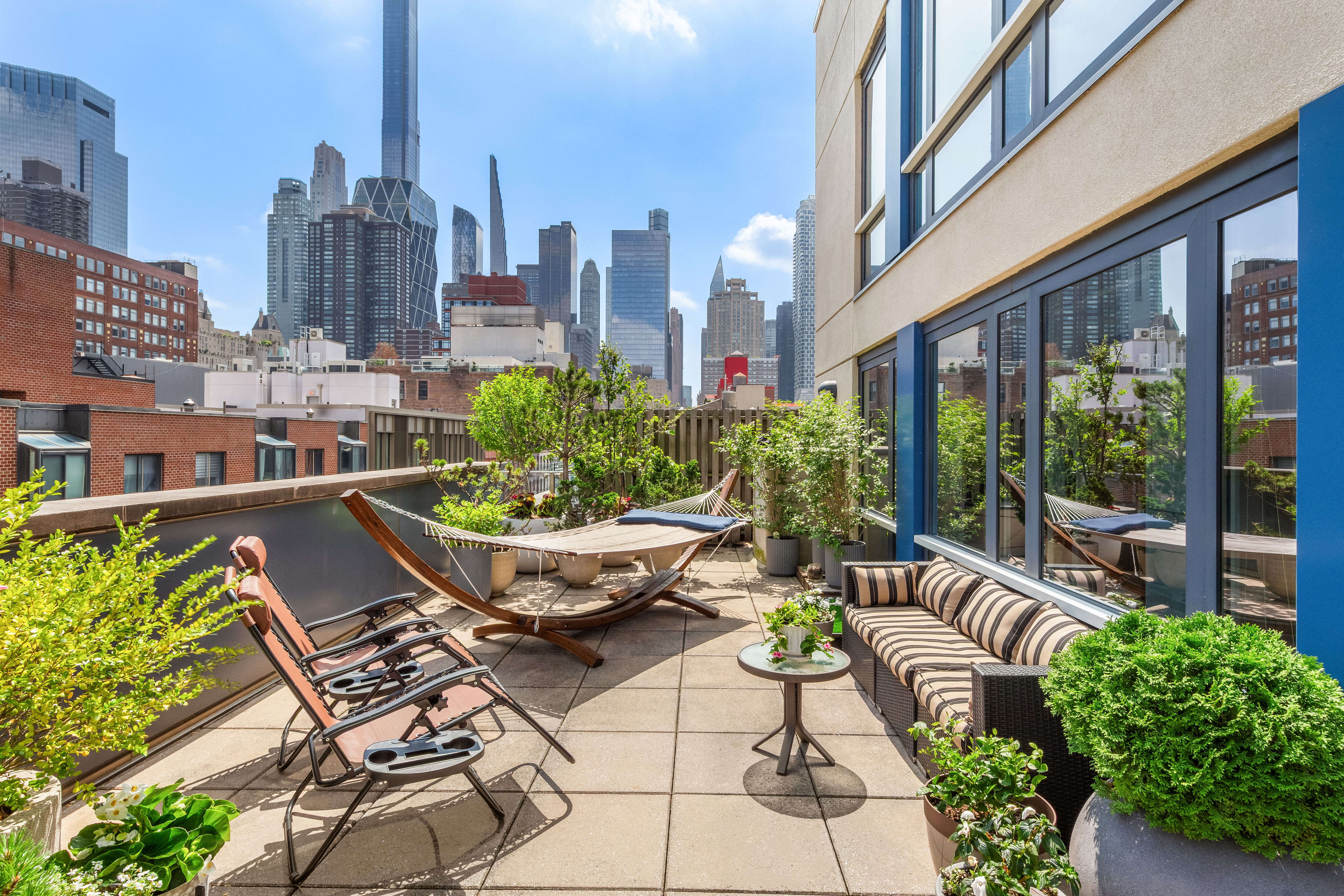 454 West 54th Street, Unit 7B Manhattan, NY 10019 - Photo 7 of 15 a view of a balcony with chairs and a table