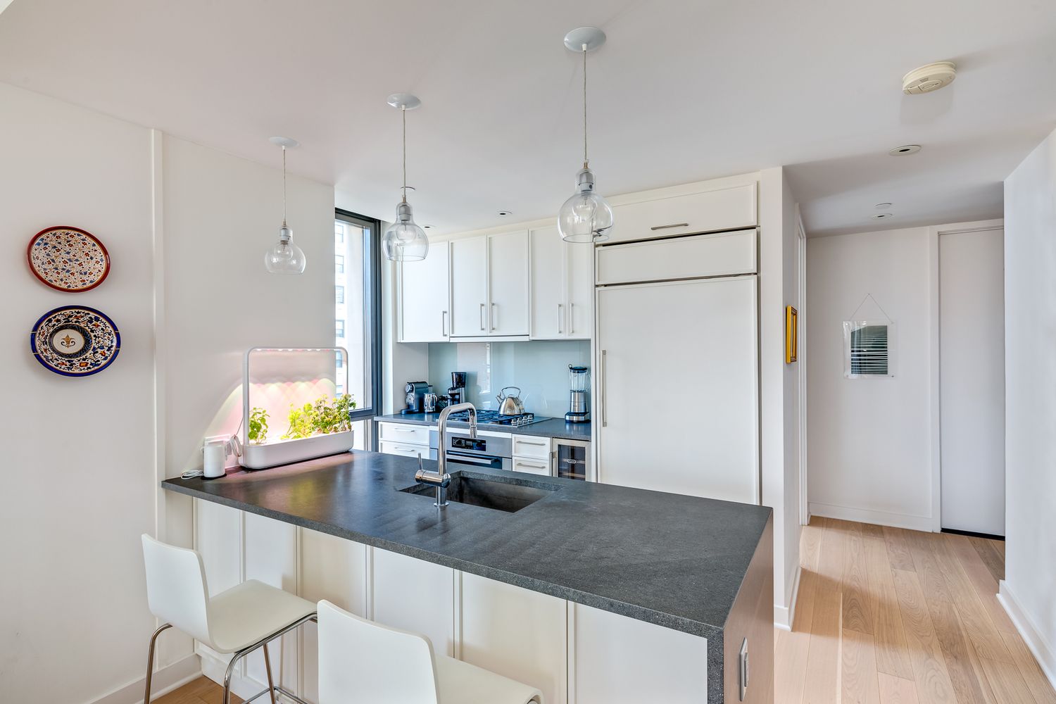 160 East 22nd Street, Unit 15C Manhattan, NY 10010 - Photo 2 of 6 a kitchen with stainless steel appliances granite countertop a sink a stove and a refrigerator