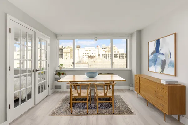 a dining room with furniture and window