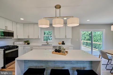 a kitchen with a table a sink and cabinets