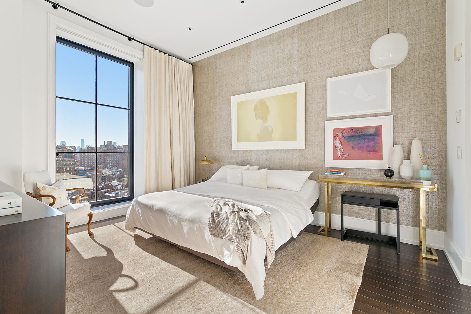 212 West 18th Street, Unit 9C Manhattan, NY 10011 - Photo 6 of 10 a bedroom with a bed and a table