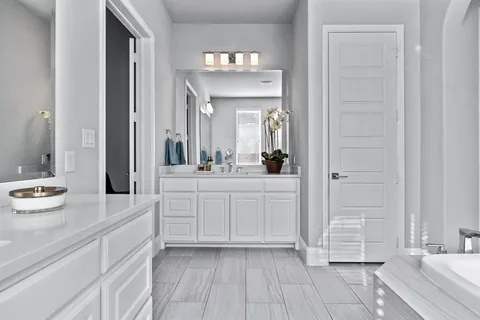 a spacious bathroom with a double vanity sink and a mirror