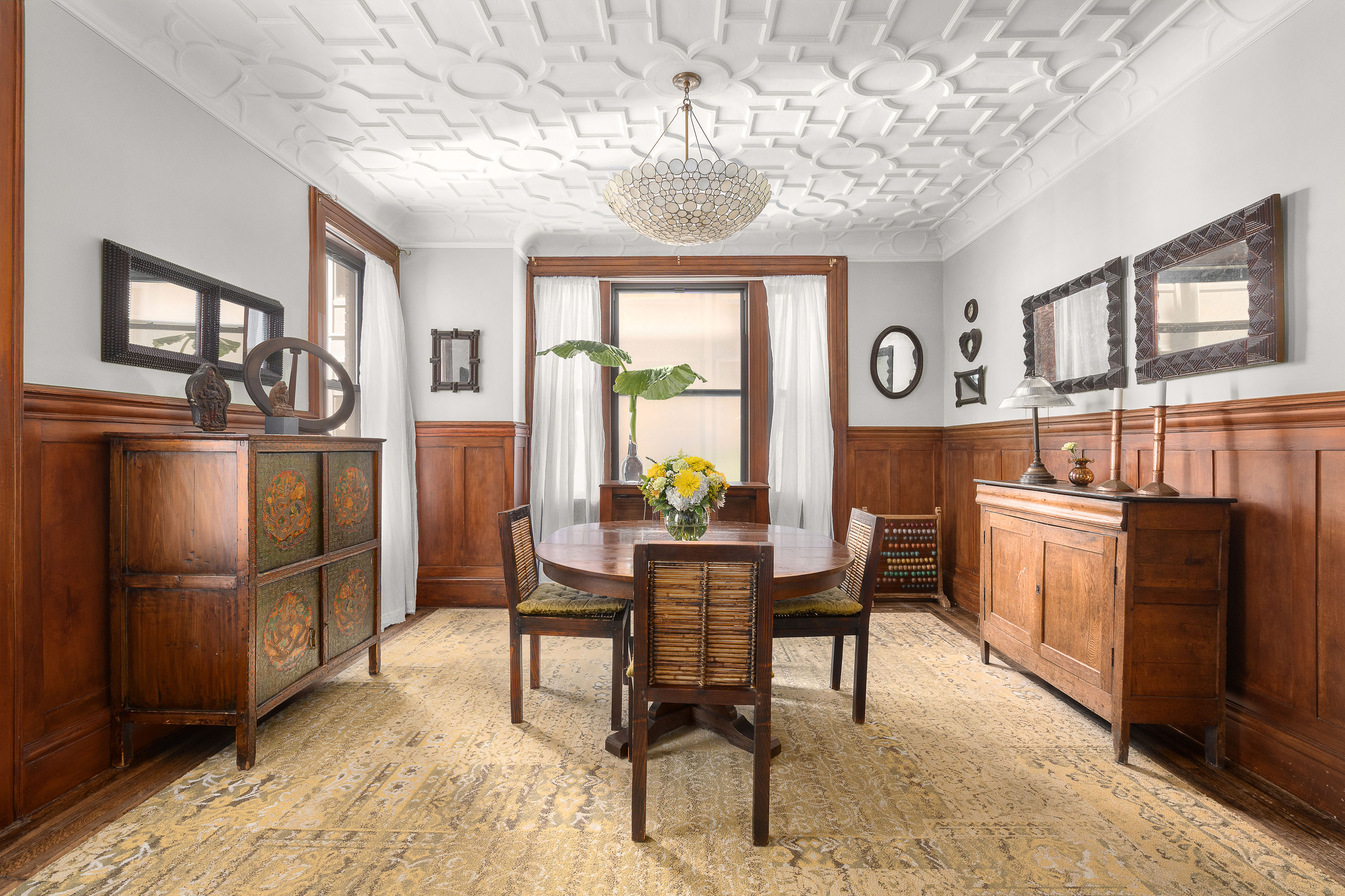 200 West 54th Street, Unit 8G Manhattan, NY 10019 - Photo 1 of 11 a dining room with furniture a chandelier and wooden floor