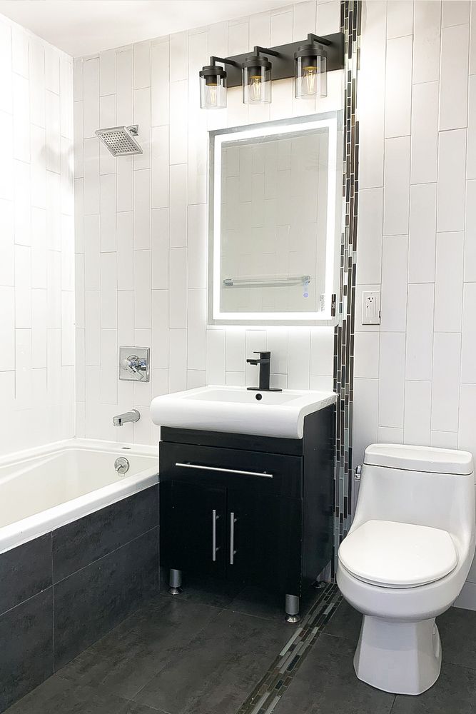452 Lafayette Avenue, Unit 4B Brooklyn, NY 11205 - Photo 13 of 15 a bathroom with a sink mirror toilet and bathtub