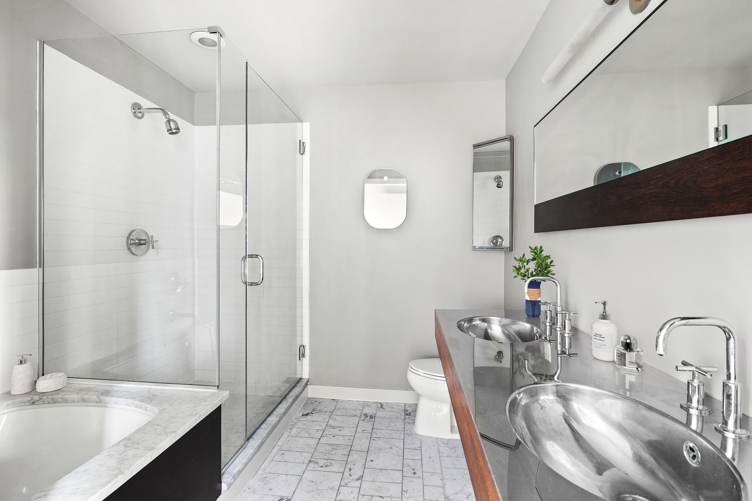 66 9th Avenue, Unit 4W Manhattan, NY 10011 - Photo 8 of 16 a bathroom with a granite countertop sink a shower and a mirror