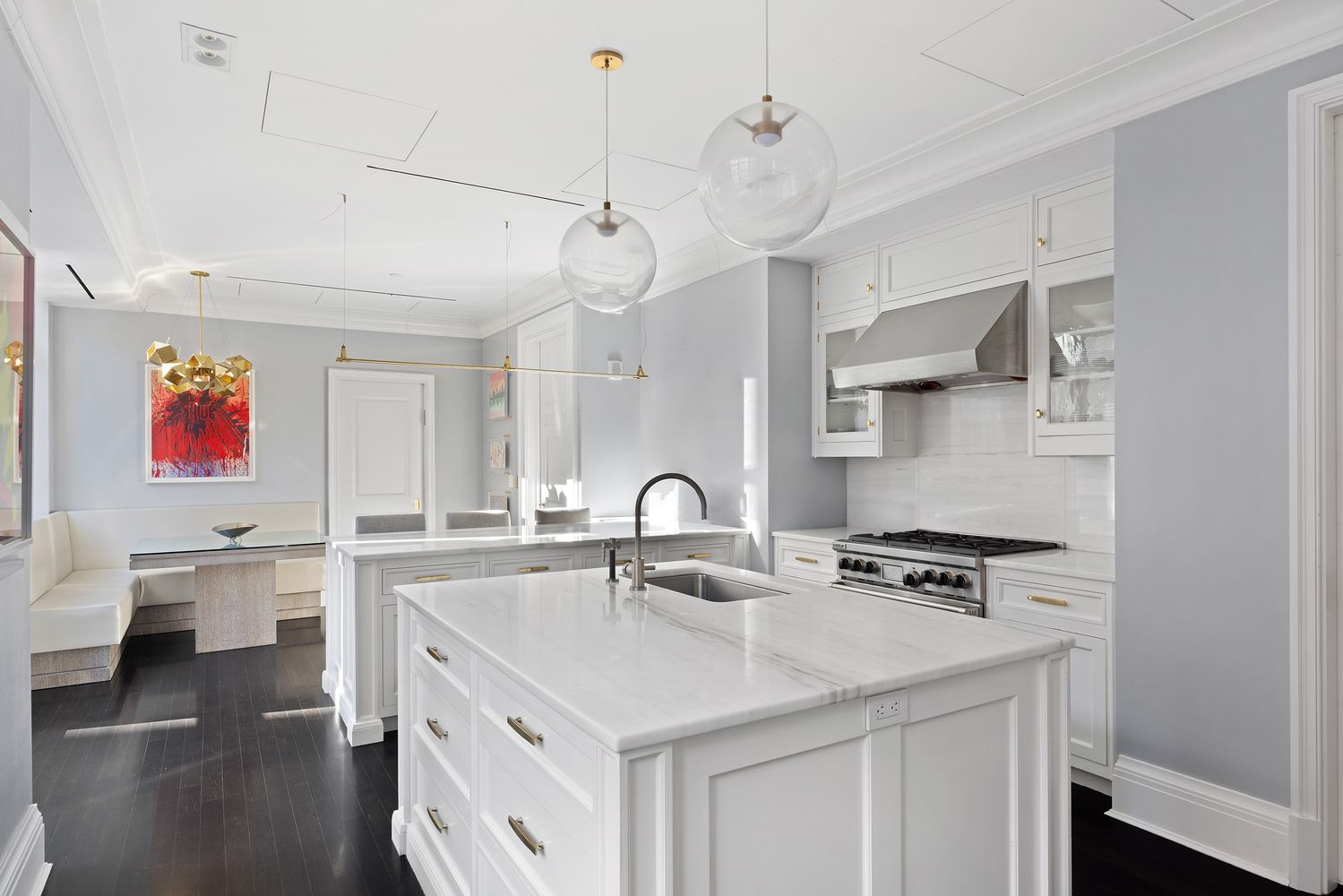 a kitchen with stainless steel appliances a sink a stove and a wooden floors