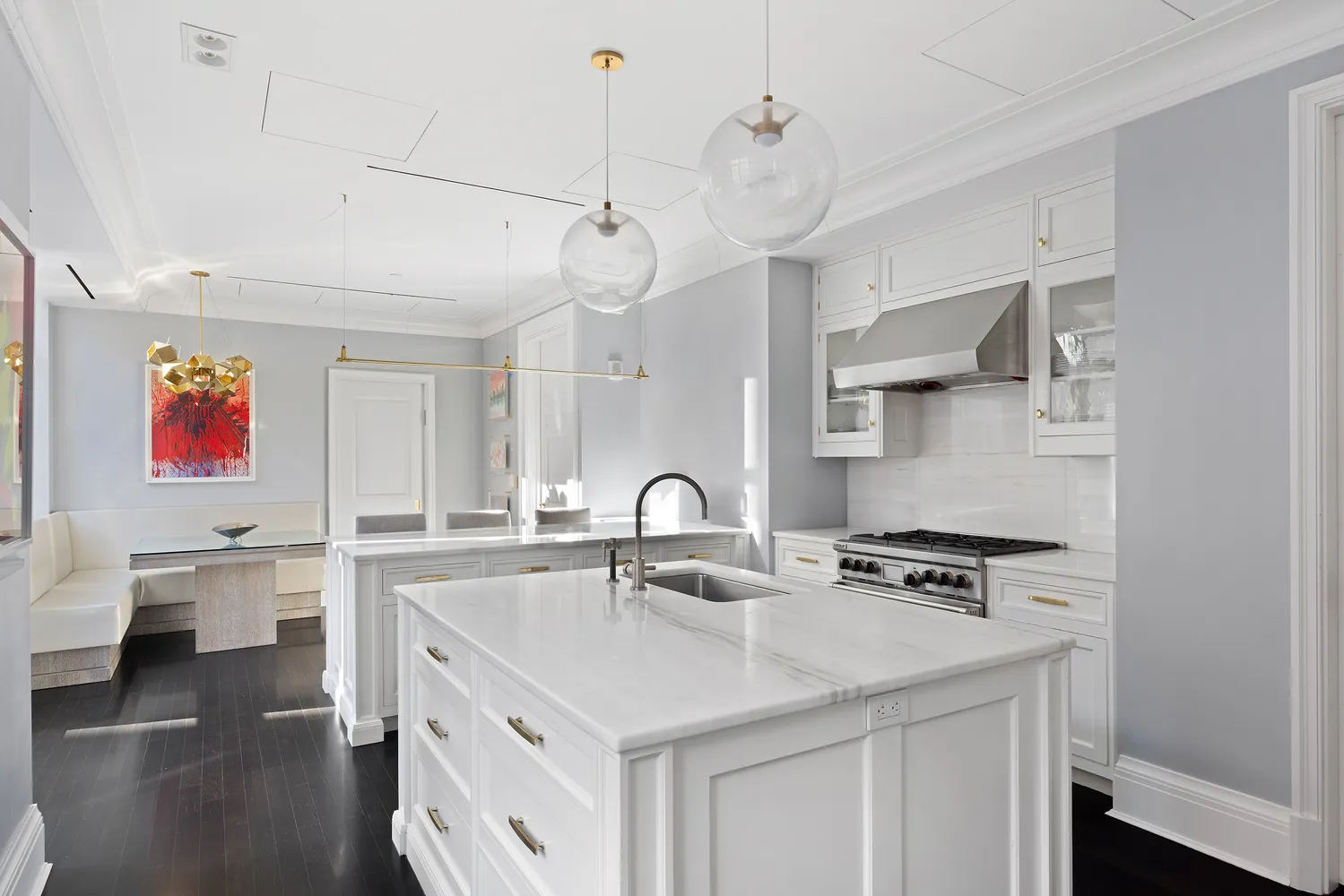 a kitchen with stainless steel appliances a sink a stove and a wooden floors