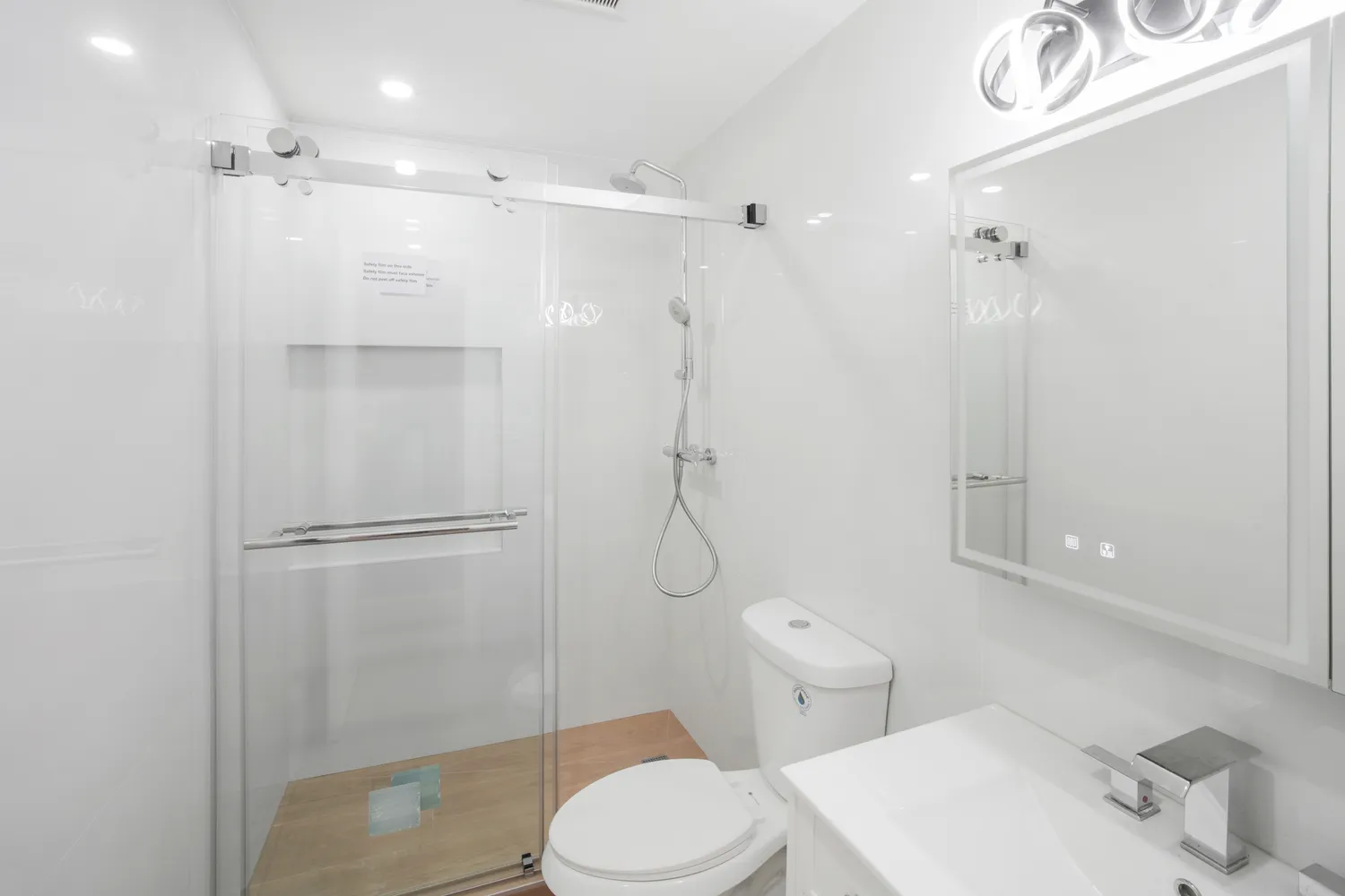 a bathroom with a shower toilet and sink