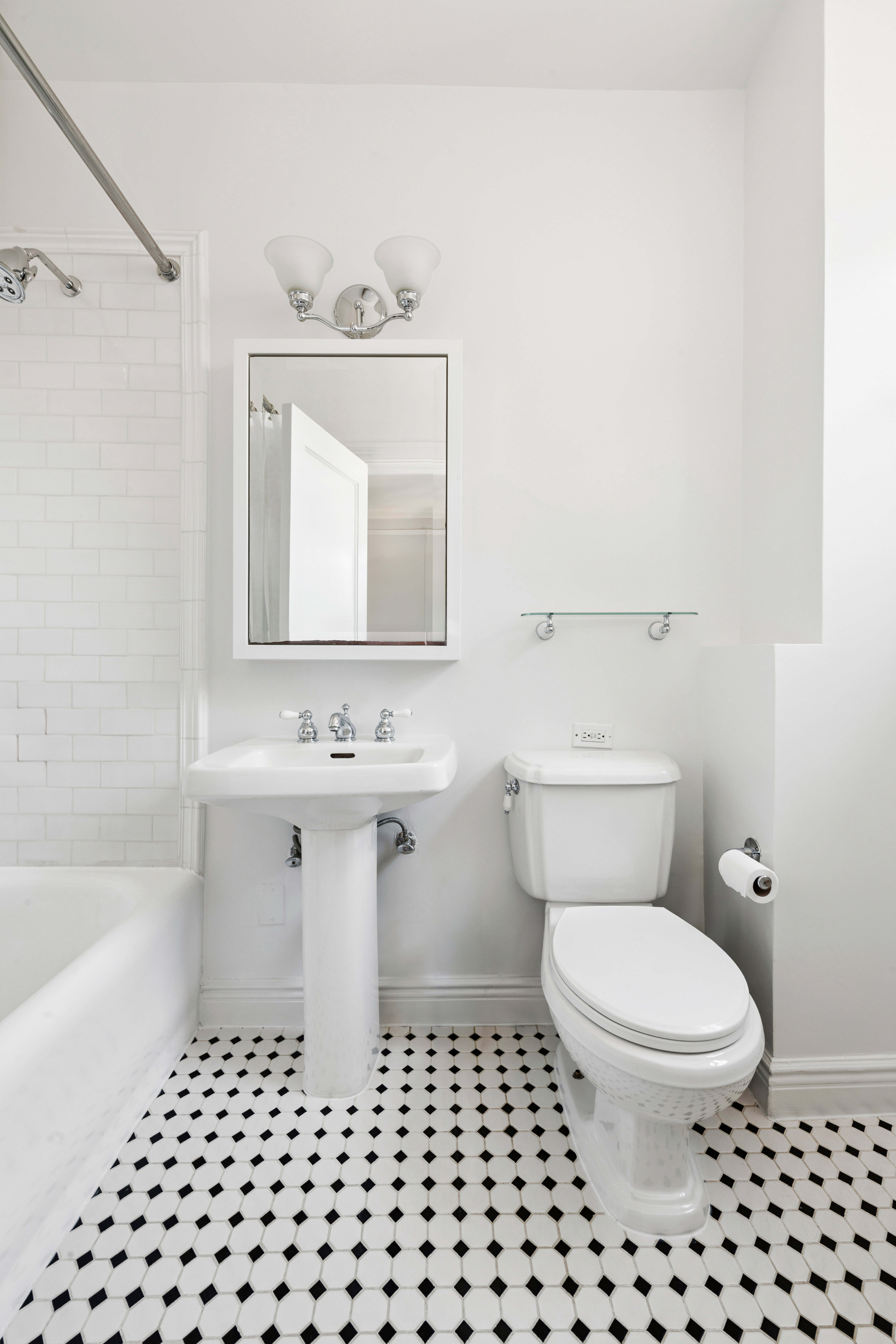 1140 5th Avenue, Unit 14B Manhattan, NY 10128 - Photo 13 of 18 a bathroom with a sink a toilet and shower
