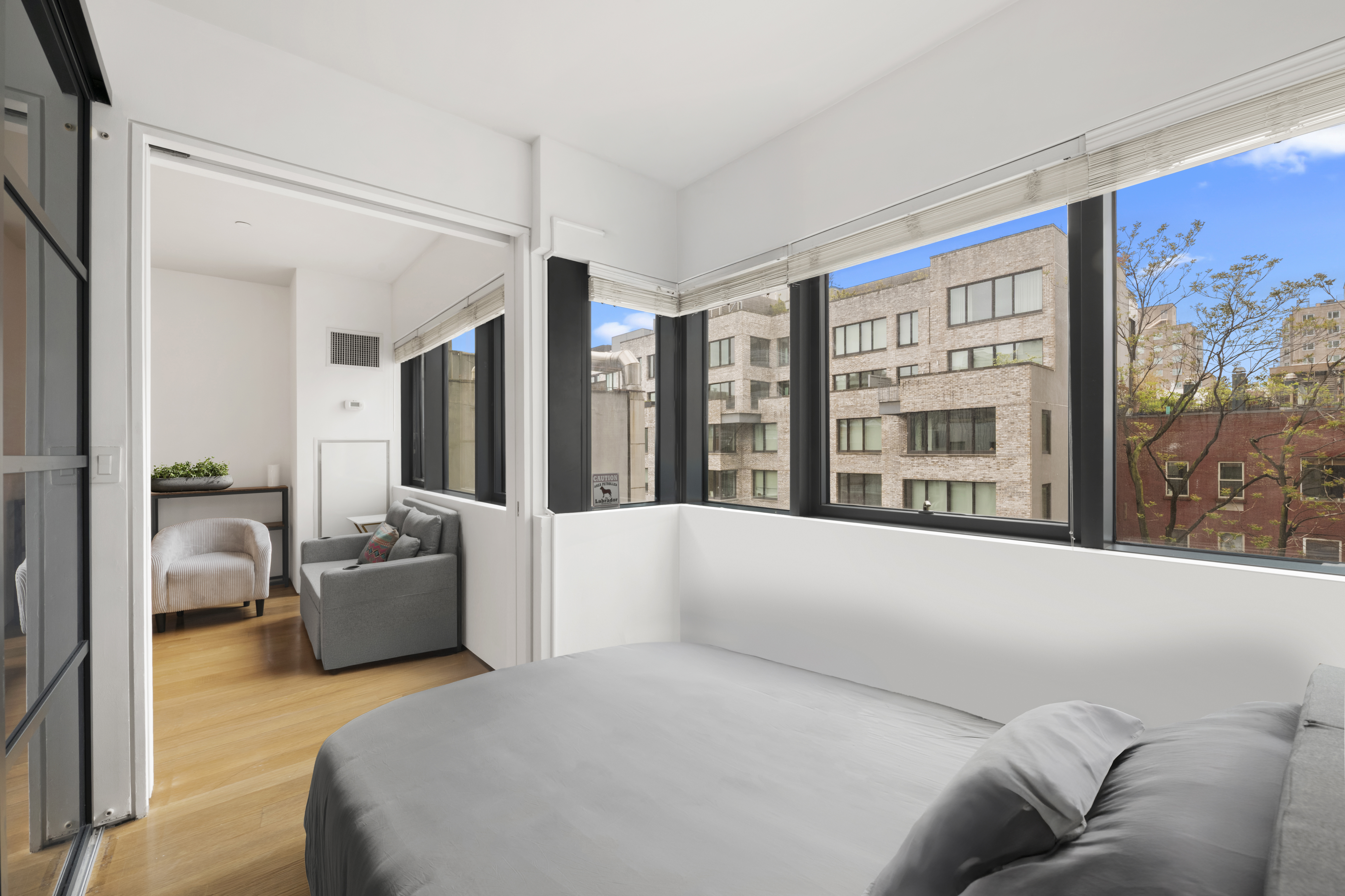 123 3rd Avenue, Unit 5D Manhattan, NY 10003 - Photo 4 of 12 a living room with furniture and large window