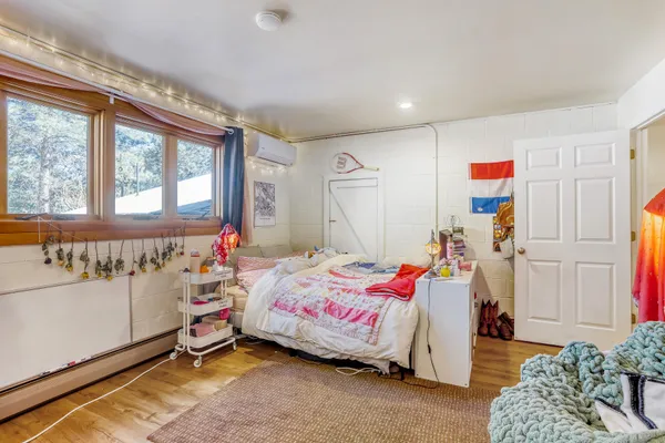 a living room with furniture a wooden floor and a window