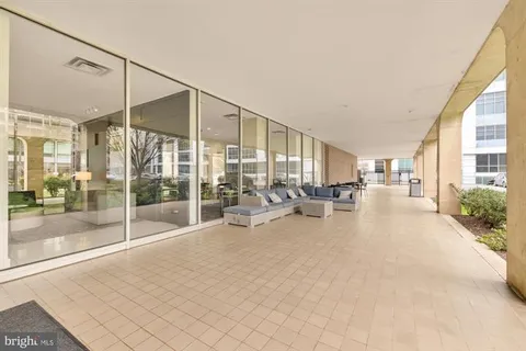 a view of a livingroom with furniture and floor to ceiling window