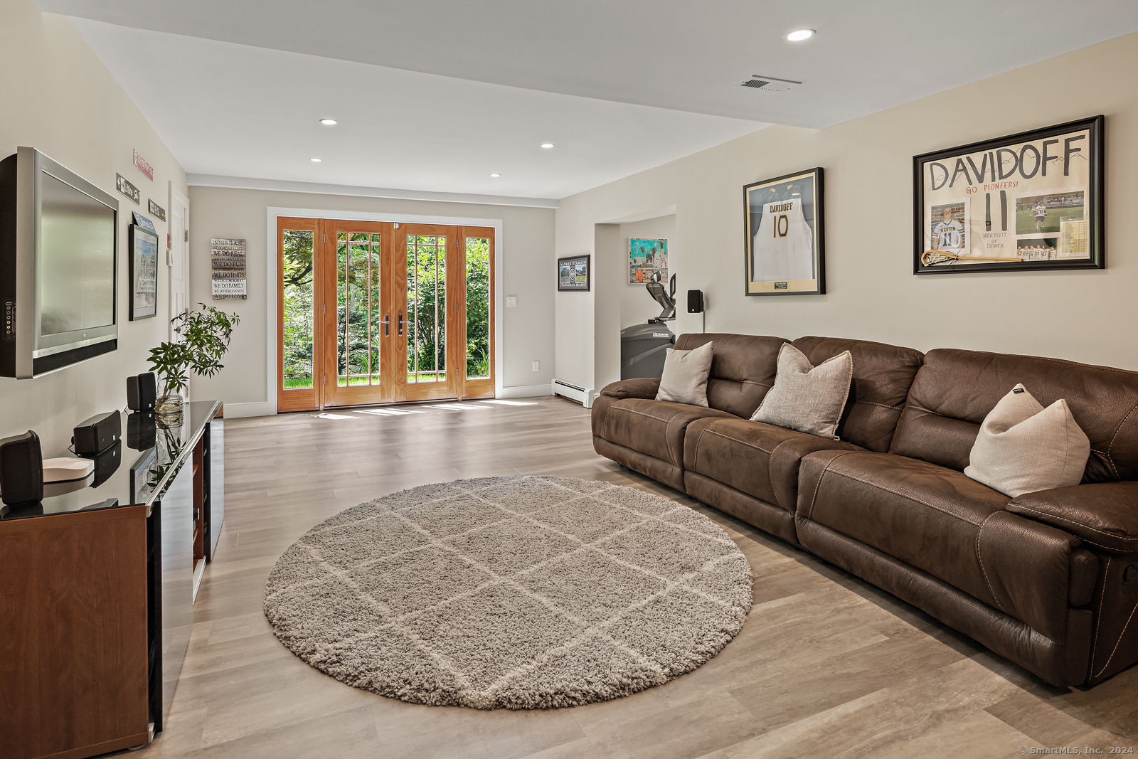 13 Bittersweet Road Weston, CT 06883 - Photo 22 of 35 a living room with furniture and a flat screen tv