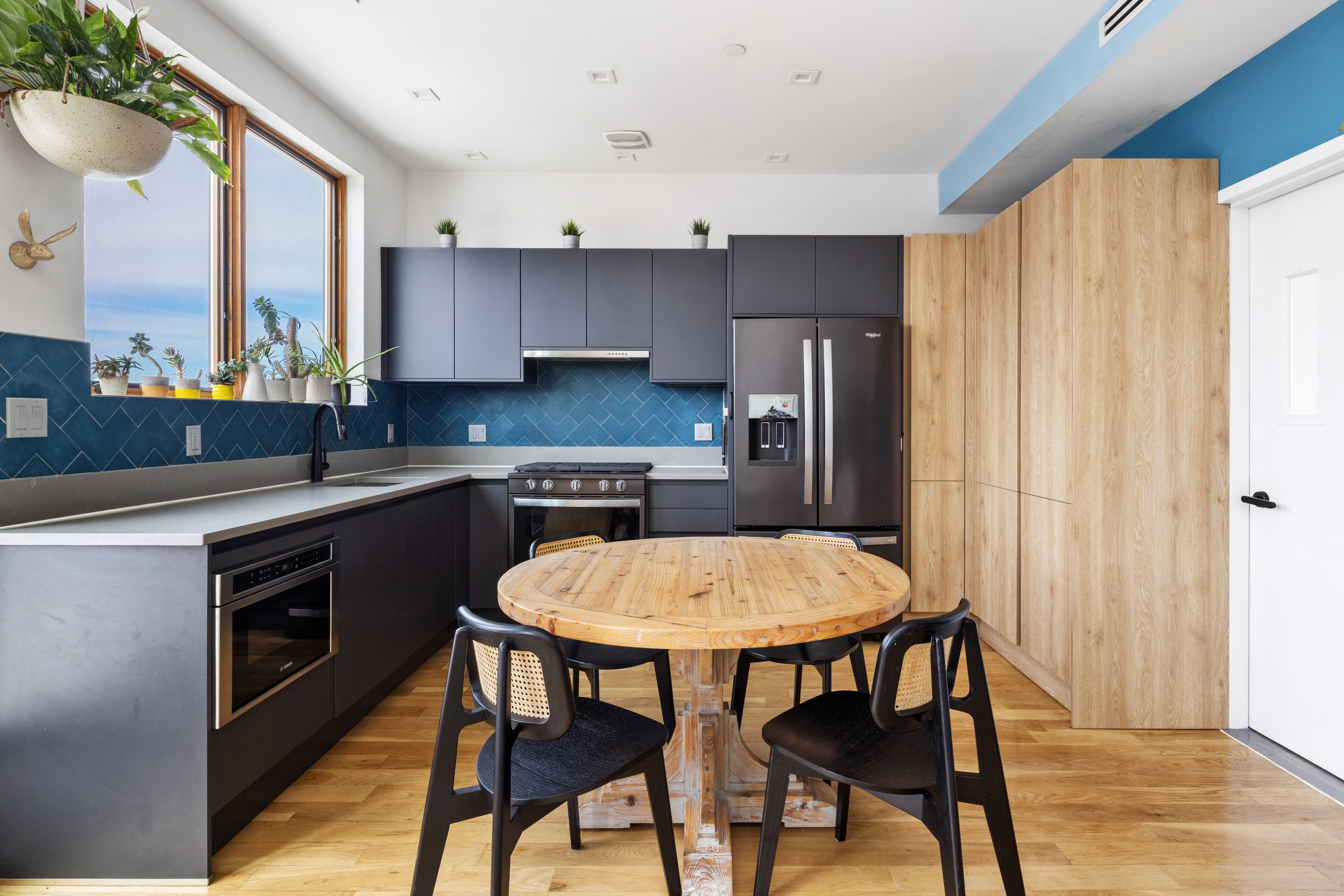 64 Stanhope Street, Unit PH Brooklyn, NY 11221 - Photo 3 of 13 a kitchen with a table chairs sink and cabinets