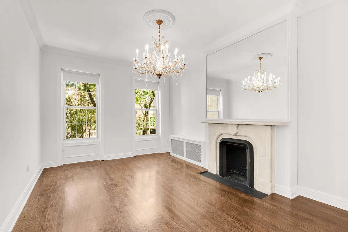 177 East 70th Street Manhattan, NY 10021 - Photo 8 of 14 a view of an empty room with wooden floor and a window