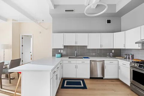 a kitchen that has a sink and a stove in it
