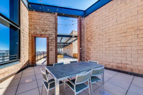 a backyard of a house with barbeque oven table and chairs