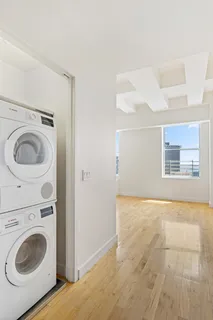 a view of a bedroom with washer and dryer