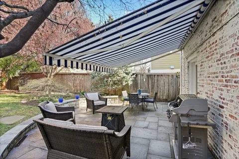 a view of a house with backyard and sitting area